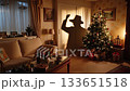 A living room with a christmas tree and a couch 133651518