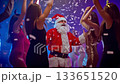 A group of people dancing with Santa Claus in a party 133651520