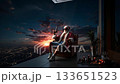 A man in a santa claus outfit sitting in a chair with a gun in his hand 133651523