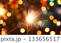 New Year's sparkler at night against a bokeh background. New Year and Christmas concept. Sylvester, New Year's party 2026. New Year. Fireworks. Holiday card with fireworks - sparklers and bokeh 133656517