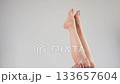 Woman applying moisturizer to her legs.  133657604