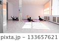 Group of mature women doing yoga indoors.  133657621