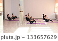 Group of mature women doing yoga indoors.  133657629