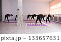 Group of mature women doing yoga indoors.  133657631