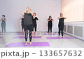 Group of mature women doing yoga indoors.  133657632