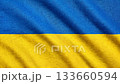 Aerial top down view of the Ukrainian flag waving in the wind, blue and yellow national colors, smooth flowing fabric, patriotic motion background for events, presentations and broadcasts 133660594