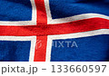 Icelandic national flag waving in the wind, top down overhead view, blue field with red and white Nordic cross fluttering, patriotic seamless video background 133660597