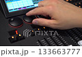 Hands of man turning shuttles on lighting mixer close up 4k 133663777