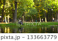 Young woman using tablet in riverside park, 4K 133663779