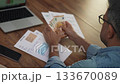 Man reaches for stack of 50-euro bills gathering banknotes in hand counting each note, worker compares amount of money in hand with account indicated on utility bill slow motion 133670089