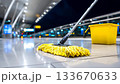 Nighttime cleaning at an airport with a mop and bucket on the floor 133670633