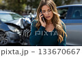 Young woman talking on phone after car accident in urban area during daylight 133670667