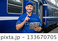Smiling train technician uses tablet at the station to manage operations in the afternoon sunlight 133670705