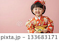 [Girls' Festival] Smiling girl in Japanese clothing holding a golden fan, portrait on a pink background 133683171