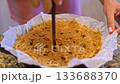 Piercing pie dough and pouring melted butter 133688370