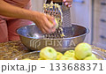 Grating apples on grater 133688371