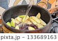 Cooking cherry and apple compote in pot 133689163
