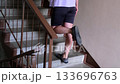 A mature woman exercising in Staircase entrance setting 133696763