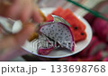 Close-up view of freshly cut dragon fruit and watermelon arranged together. The vibrant red and purple colors highlight freshness, health, and natural nutrition. Perfect for themes related to healthy  133698768