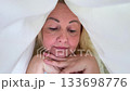 Close up face happy woman laughing smiling rejoice flirt girl looking duvet peek out female toothy dental smile bedroom home pleasure tenant glad enjoying joy bed positive dentistry delight homeowner 133698776