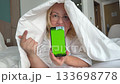 green screen for chroma key advertising Woman lying in bed with telephone 133698778