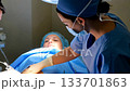 Female surgeon operates on Caucasian woman in hospital. Ai generated 133701863