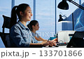 Young Asian female coder works late in tech office. Ai generated 133701866