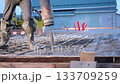 Pouring mixed concrete after installing steel reinforcement to create house.  133709259