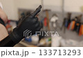 carbon fiber, functional enhancement, independence support. Detailed close-up shows carbon fiber prosthetic hand covered with black glove in natural resting position. 133713293