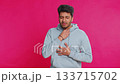 Unhealthy Indian young man coughing covering mouth with hand feeling sick over pink background 133715702