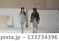 Artistic discussion between two women in a spacious studio setting showcasing creative expression and collaboration Artistic discussion between two women in a spacious studio setting showcasing creative expression and collaboration 133734396