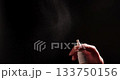 Hand Uses Nasal Spray on a Dark Background, Showcasing Spraying and Potential Addiction Concept 133750156