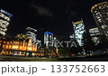 Tokyo, Japan: Tokyo Station and skyscrapers, business district at night (time lapse photography) 133752663