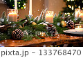 Snowflakes fall softly onto beautifully set table with lit candles and pine cones. Cozy video to create Christmas atmosphere 133768470
