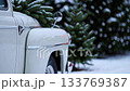 Vintage truck by festive christmas lights in snowy winter wonderland 133769387