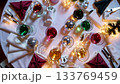 Elegant holiday dining table with colorful drinks and festive decor sparkles 133769459