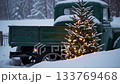 Vintage truck with snowcovered christmas tree illuminating a peaceful winter scene 133769468