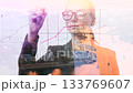 Double exposure of a business woman draws various growth charts 133769607