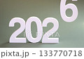 hand pick up the number 5 and place the number 6 in it place., changing from year 2025 to 2026 for new year sign on green background, 2026 New Year celebration transition from 2025 to 2026 concept 133770718