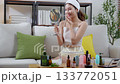 Beauty young asian woman looking mirror for check wrinkles on facial in living room. 133772051