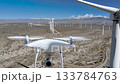 Palm Springs, California wind farm footage shot by drone featuring an inspection drone in the scene, combining aerial perspectives with dynamic UAV visuals. 133784763
