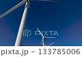 Drone rising upward over wind turbines in the San Gorgonio Pass near Palm Springs, California. Expanding aerial view of clean energy infrastructure across desert terrain. 133785006
