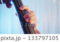 Super close-up of the hands of a person playing the double bass 1 133797105