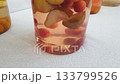 Footage of floating fruits in a glass jar, Compote 133799526