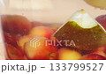 Footage of floating fruits in a glass jar, Compote 133799527