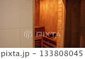 dry sauna, wellness therapy, warm lighting. Traditional dry sauna room made wood, featuring bench seating and soft amber lighting, ready for relaxation and heat therapy. 133808045