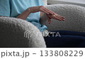 Practice with hand movements focused on finger dexterity and coordination at home in a cozy setting 133808229