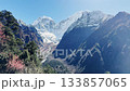 Himalayas majestic view, snowy mountains peaks, panoramic nature background of a Himalayan mountain range covered with white snow, green valley under the mountain. 133857065