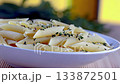 Cooked Gluten Free Pasta Bowl With Herbs on a Sunny Outdoor Table Setting at Noon 133872501