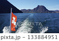 Lake Lugano with a boat wake, Swiss flag and Mount San Salvatore. Lugano, Ticino, Switzerland 133884951